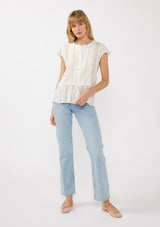 [Color: White/Coral] A front facing image of a blonde model wearing an off white yarn dye stripe top with embroidered eyelet details. This sheer cotton top features a round neckline, button front, short sleeves, and a peplum waist with an adjustable drawstring. Perfect for casual outings and resort styling. 