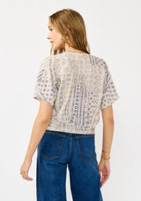 [Color: Oatmeal/Plum] A back facing image of a blonde model wearing a boho floral tie front top with short dolman sleeves, a v-neckline, and button front. 