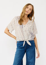 [Color: Oatmeal/Plum] A front facing image of a blonde model wearing a boho floral tie front top with short dolman sleeves, a v-neckline, and button front. 