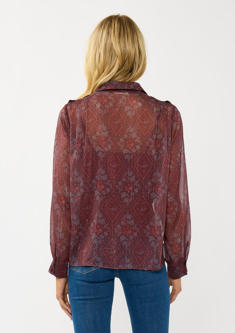 [Color: Wine/Rose] A back facing image of a blonde model wearing a floral diamond print chiffon blouse with metallic thread details. Featuring metallic thread details, a button front, and long sleeves with a tailored cuff. A special occasion top for the fall season. 