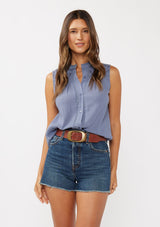 [Color: Denim Blue] A front facing image of a brunette model wearing a blue classic boho tank top with a button front, embroidered yoke, and lace trim accents. 