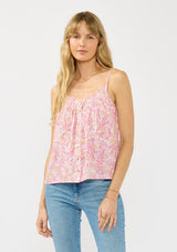 [Color: Natural/Dusty Rose] A front facing image of a blonde model wearing a pink floral print camisole with a smocked neckline, button front, and adjustable spaghetti straps. 