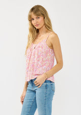 [Color: Natural/Dusty Rose] A side facing image of a blonde model wearing a pink floral print camisole with a smocked neckline, button front, and adjustable spaghetti straps. 