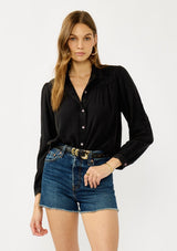 [Color: Black] A front facing image of a blonde model wearing a soft vintage wash black shirt with tonal embroidered details. Featuring a classic collar neckline, button front, and button cuff. 