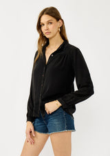 [Color: Black] A front facing image of a blonde model wearing a soft vintage wash black shirt with tonal embroidered details. Featuring a classic collar neckline, button front, and button cuff. 