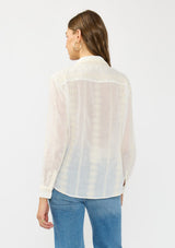 [Color: White/Natural] A back facing image of a brunette model wearing a white embroidered shirt with a button front and collar. 
