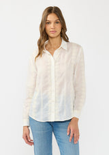 [Color: White/Natural] A front facing image of a brunette model wearing a white embroidered shirt with a button front and collar. 