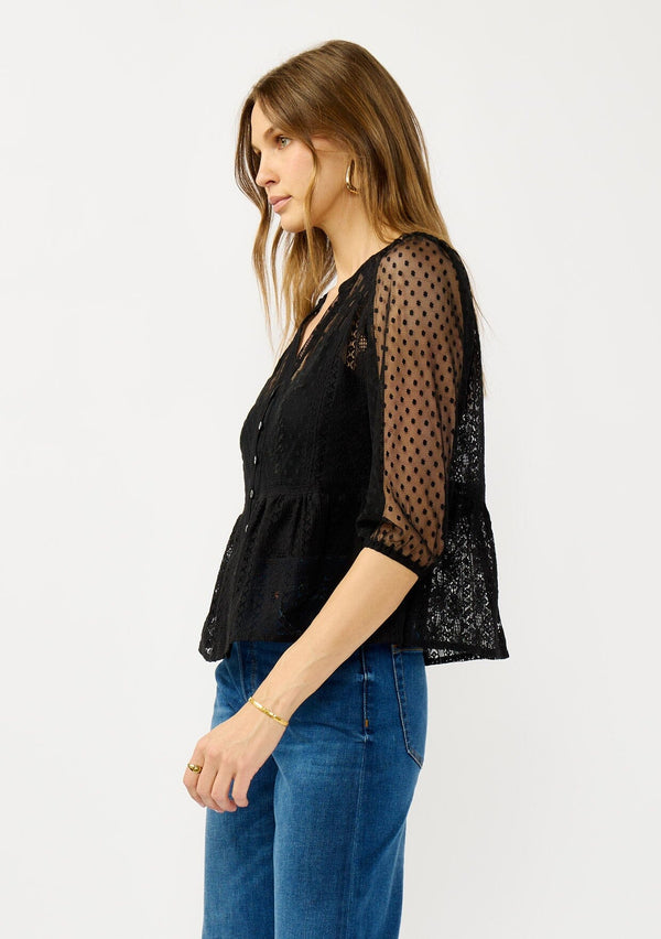 [Color: Black] A side facing image of a blonde model wearing a Victorian mixed lace top with 3/4 length sleeves, a split v-neckline, button front, and a subtle peplum-style silhouette. A versatile black fall lace top. 