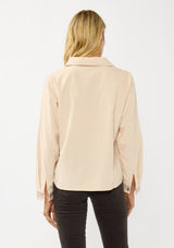 [Color: Vanilla] A back facing image of a blonde model wearing a corduroy shirt with floral embroidery, a button front, and a collar neck. A soft and comfortable shirt for the fall season. 
