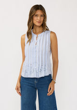 [Color: Blue] A front facing image of brunette model wearing a light blue tank top with a button front, pintuck details, and an eyelet embroidered hem. 
