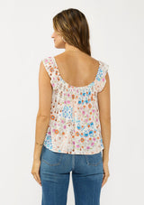 [Color: Ivory/Orange] A back facing image of a brunette model wearing a blue and orange floral top with cap sleeves and a smocked scoop neckline. 