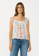 [Color: Ivory/Orange] A front facing image of a brunette model wearing a blue and orange floral top with cap sleeves and a smocked scoop neckline. 