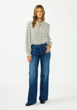[Color: Black] A front facing image of a brunette model wearing a checkered pattern blouse with embroidered details and a button front. Styled tucked in to a dark wash denim. 