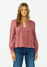 [Color: Rose Brown] A front facing image of a brunette model wearing a bohemian embroidered blouse with lace and pintuck details. Paired with a dark wash denim. 
