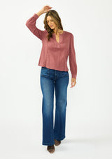 [Color: Rose Brown] A front facing image of a brunette model wearing a bohemian embroidered blouse with lace and pintuck details. Paired with a dark wash denim. 