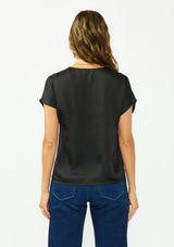 [Color: Black] A back facing image of a brunette model wearing a black satin top with an embroidered trim and short dolman sleeves. 