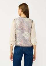 [Color: Natural/Lavender] A back facing image of a blonde model wearing a cozy fall floral sherpa vest with a tie front detail and side pockets. Perfect for layering any boho look. 