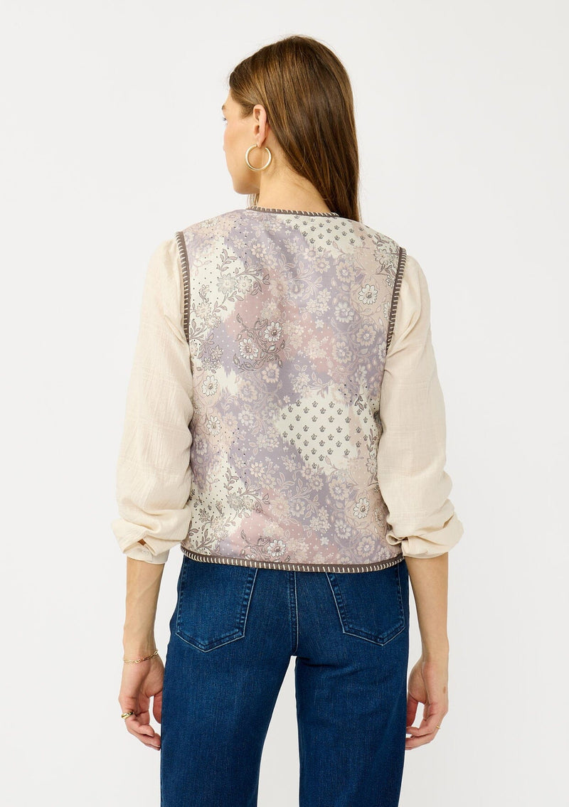 [Color: Natural/Lavender] A back facing image of a blonde model wearing a cozy fall floral sherpa vest with a tie front detail and side pockets. Perfect for layering any boho look. 