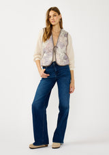 [Color: Natural/Lavender] A front facing image of a blonde model wearing a cozy fall floral sherpa vest with a tie front detail and side pockets. Perfect for layering any boho look. 