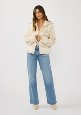 [Color: Ivory/Taupe] A front facing image of a brunette model wearing an ivory plaid jacket with a zip up front and side pockets. 