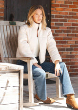 [Color: Natural] A front facing image of a blonde model wearing a light beige soft knit puffer jacket with a zipper front, high collar, and side pockets. A classic fall jacket for cold weather. 