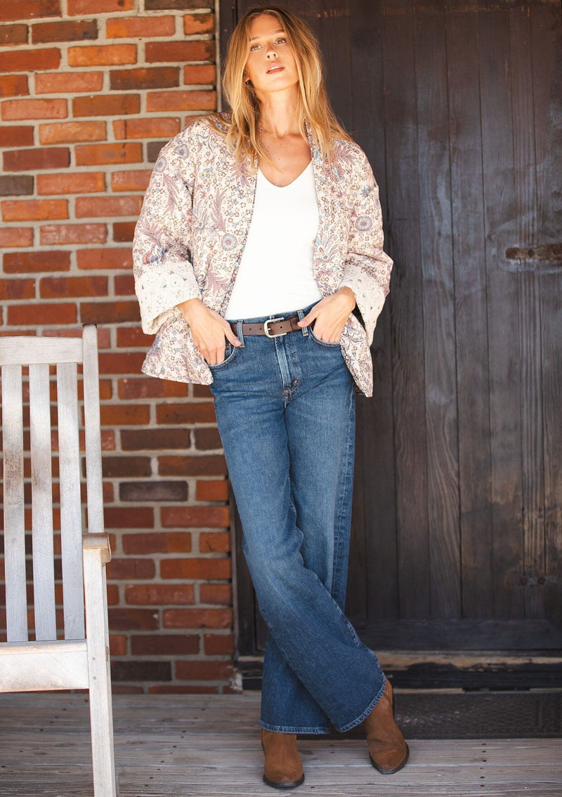 [Color: Mauve/Natural] A front facing image of a blonde model wearing a mauve pink floral bohemian jacket with an oversized fit, long sleeves, crochet trim, and side pockets. 