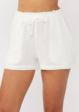 [Color: White] A front facing image of white cotton gauze shorts with an elastic drawstring waist and side pockets. Perfect for spring, lounging, or beach days. 