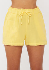 [Color: Yellow] A front facing image of yellow cotton gauze shorts with an elastic drawstring waist and side pockets. Perfect for spring, lounging, or beach days. 