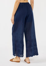 [Color: Navy] A back facing image of a navy eyelet pant with a beaded drawstring and side pockets. 