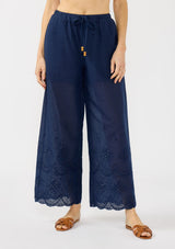 [Color: Navy] A front facing image of a navy eyelet pant with a beaded drawstring and side pockets. 