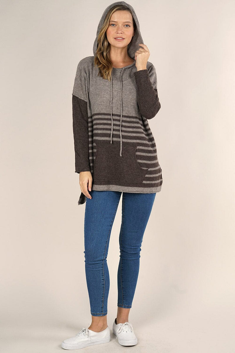 [Color: Cement/Dark Chocolate] An image of a blonde model wearing a grey and brown striped pullover hoodie with a contrast sleeve, drawstring, and kangaroo pockets. Casual and laid back for the fall season. 