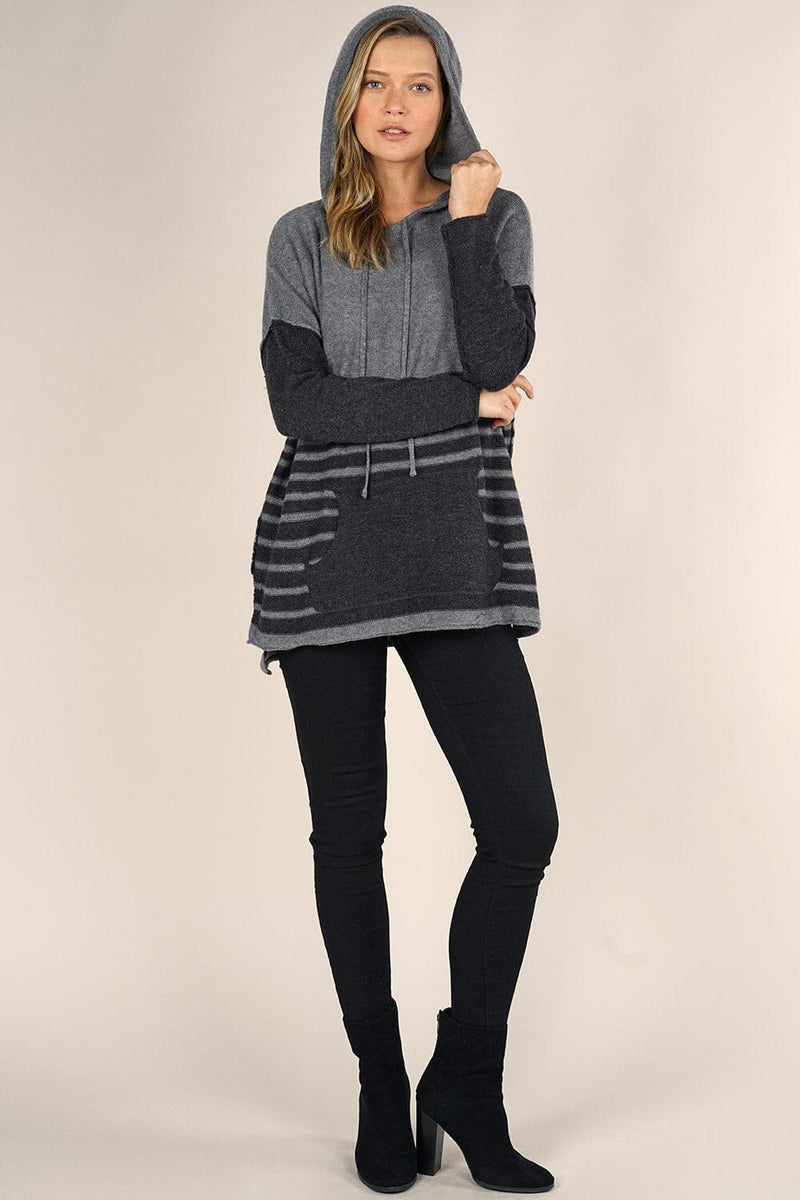 [Color: Grey/Charcoal] An image of a blonde model wearing a grey striped pullover hoodie with a contrast sleeve, drawstring, and kangaroo pockets. Casual and laid back for the fall season. 