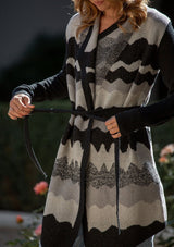 [Color: Black/Grey] A detail image of a blonde model wearing an abstract cardigan with an adjustable waist belt. 