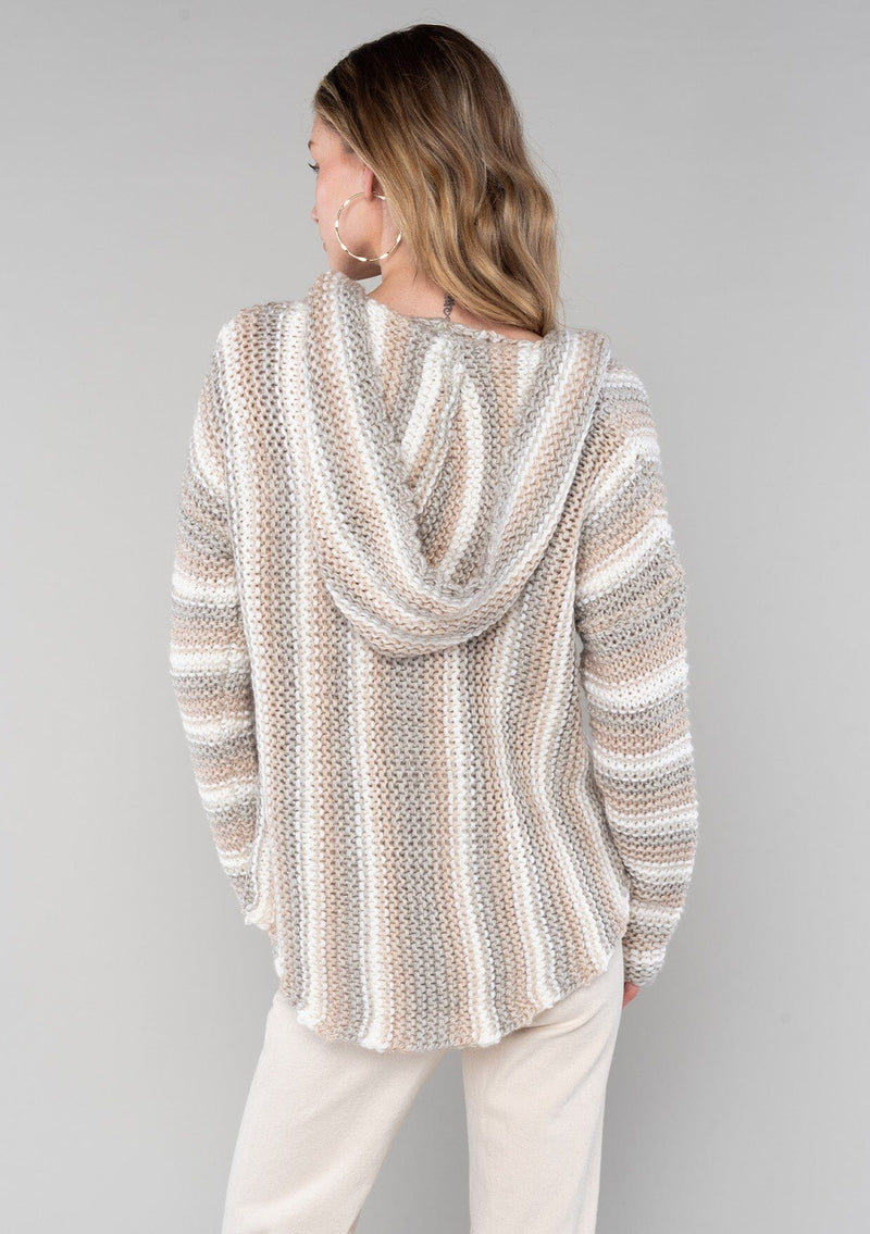 [Color: Ash/Cream] A back facing image of a blonde model wearing a vertical striped knit pullover with a hoodie, relaxed v-neckline, and cozy long sleeves. A classic knit sweater for casual outings. 