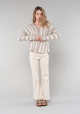 [Color: Ash/Cream] A front facing image of a blonde model wearing a vertical striped knit pullover with a hoodie, relaxed v-neckline, and cozy long sleeves. A classic knit sweater for casual outings. 