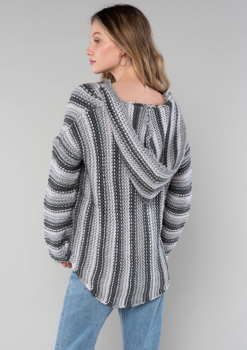 [Color: Smoke/Steel] A back facing image of a blonde model wearing a vertical striped knit pullover with a hoodie, relaxed v-neckline, and cozy long sleeves. A classic knit sweater for casual outings. 