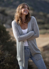 [Color: Heather Grey] A front facing image of a blonde model wearing a soft light grey knit cardigan with a button front. 