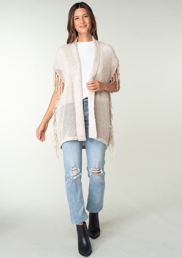 [Color: Bone] A front facing image of a brunette model wearing a open knit lightweight cardigan with fringe accents. An easy throw on for casual outings. 