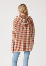 [Color: Rust/Natural] A back facing image of a blonde model wearing a fuzzy hooded cardigan in a brown plaid check design. With long sleeves and an open front.
