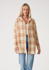 [Color: Taupe/Blue] A front facing image of a blonde model wearing a fuzzy hooded cardigan in a brown plaid design. With long sleeves and an open front. 