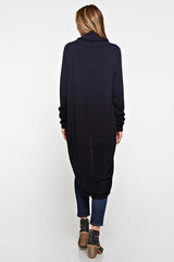 [Color: Navy/Black] A back facing image of a blonde model wearing a dip dyed cocoon cardigan with a shawl collar and long sleeves. A versatile cardigan that can transition from a duster to a mid-length cardigan. 