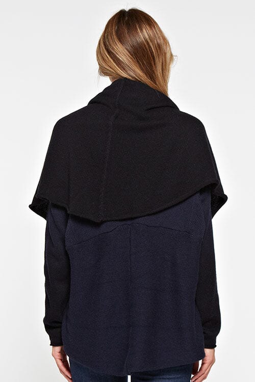 [Color: Navy/Black] A back facing image of a blonde model wearing a dip dyed cocoon cardigan with a shawl collar and long sleeves. A versatile cardigan that can transition from a duster to a mid-length cardigan. 