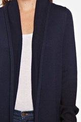 [Color: Navy/Black] A detail image of a blonde model wearing a dip dyed cocoon cardigan with a shawl collar and long sleeves. A versatile cardigan that can transition from a duster to a mid-length cardigan. 
