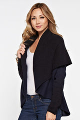 [Color: Navy/Black] A side facing image of a blonde model wearing a dip dyed cocoon cardigan with a shawl collar and long sleeves. A versatile cardigan that can transition from a duster to a mid-length cardigan. 