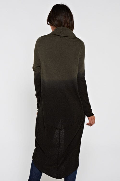 [Color: Olive/Black] A back facing image of a blonde model wearing a dip dyed cocoon cardigan with a shawl collar and long sleeves. A versatile cardigan that can transition from a duster to a mid-length cardigan. 