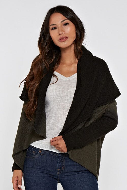 [Color: Olive/Black] A front facing image of a blonde model wearing a dip dyed cocoon cardigan with a shawl collar and long sleeves. A versatile cardigan that can transition from a duster to a mid-length cardigan. 