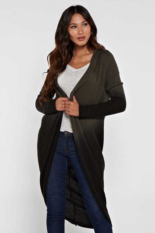 [Color: Olive/Black] A front facing image of a blonde model wearing a dip dyed cocoon cardigan with a shawl collar and long sleeves. A versatile cardigan that can transition from a duster to a mid-length cardigan. 