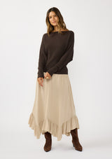 [Color: Dark Brown] A front facing image of a blonde model wearing a brown waffle knit pullover sweater. With long sleeves, a relaxed fit, and a wide neckline that can be worn off the shoulder.