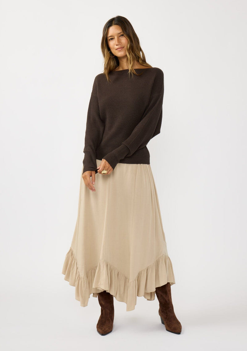 [Color: Dark Brown] A front facing image of a blonde model wearing a brown waffle knit pullover sweater. With long sleeves, a relaxed fit, and a wide neckline that can be worn off the shoulder.