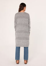[Color: Heather Grey] A back view of a brunette woman modeling a long, open-front gray mélange knit cardigan over a white top and blue jeans.